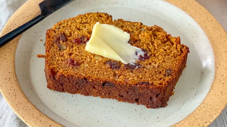 Slice of pumpkin banana bread with butter