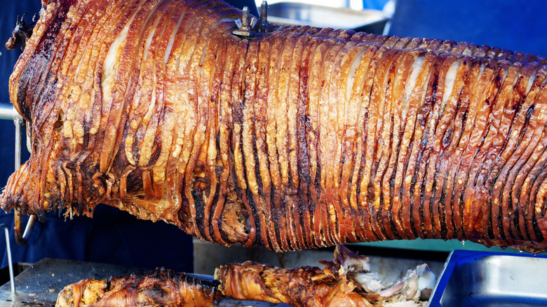 whole hog being barbecued on a spit