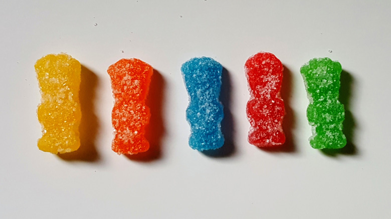 Each flavor of original Sour Patch Kids is lined up in a row