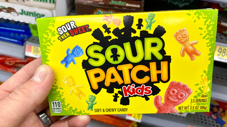 person holding a box of Sour Patch Kids at the store