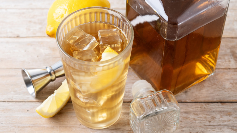 whiskey soda with lemon and liquor in bottle