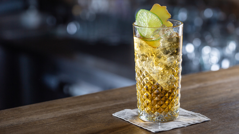 Whiskey soda in highball glass on bar