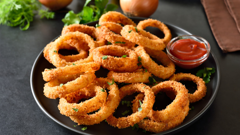 Homemade onion rings with ketchup on a plate