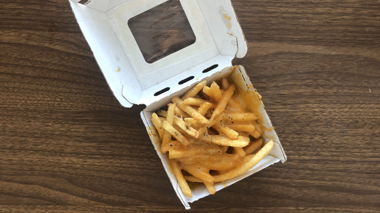 Buffalo Wild Wings cheese fries in a to-go container