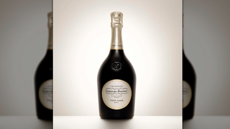 A bottle of Laurent-Perrier in front of a simple plain background