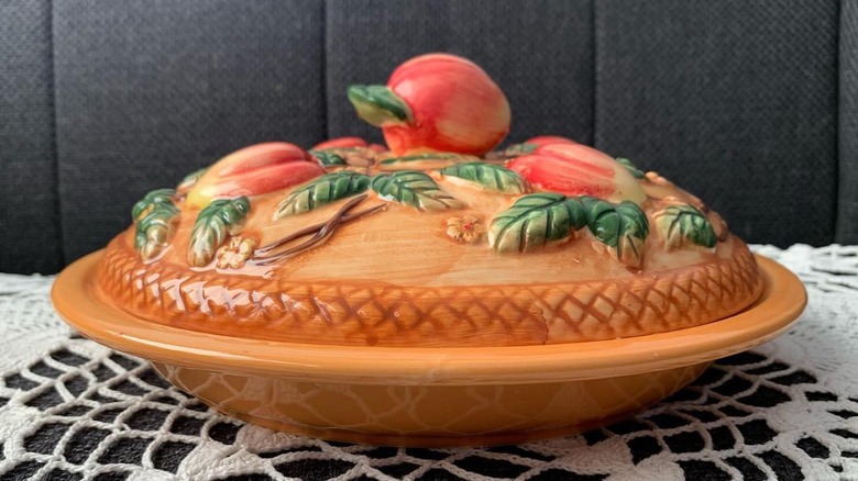 Ceramic pie keeper on crocheted tablecloth