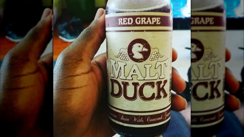 Hand holding Malt Duck bottle