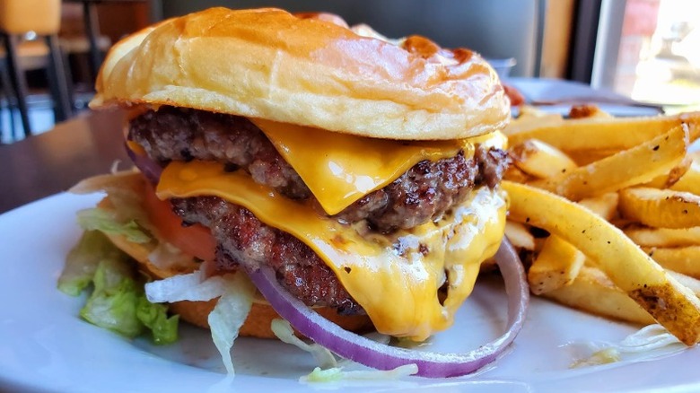 Close-up of Ruby Tuesday double smash burger with cheese and French fries