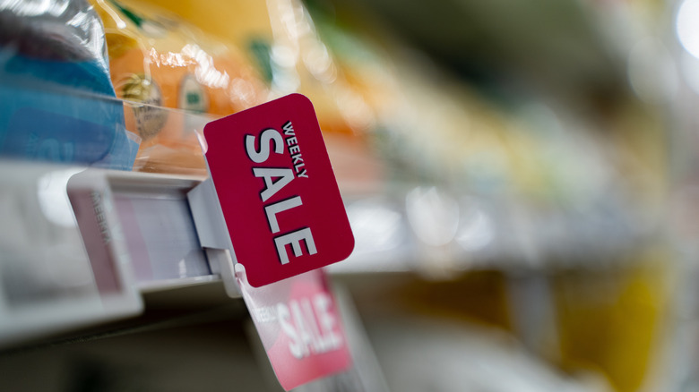 sale sign on grocery store shelf