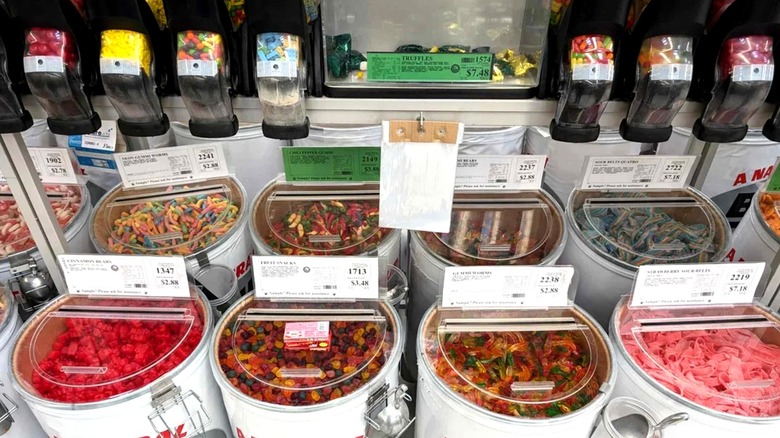 Bulk plastic bins and dispensers of various candies inside WinCo grocery store