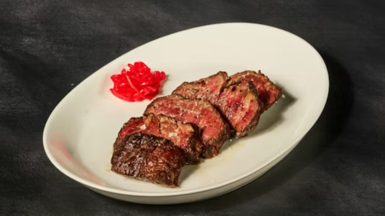 STK Steakhouse Steakhouse Skirt steak sliced on a plate.