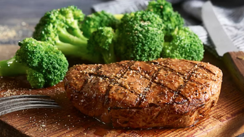 Logans' Roadhouse 6-ounce center cut sirloin on wood platter.