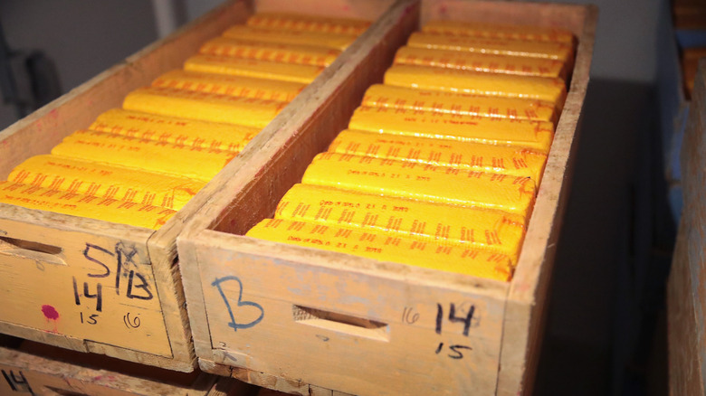 Wooden crates packed with bricks of cheddar cheese