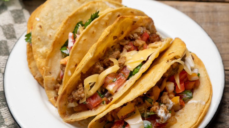 freshly fried hard shelled tacos with beef and pico de gallo