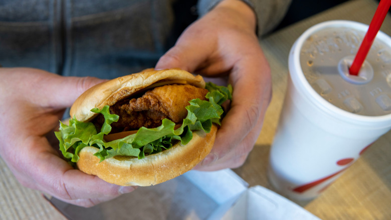 Hands holding chick-fil-a sandwich