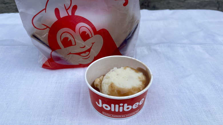 Jollibee mashed potatoes against a white tablecloth.