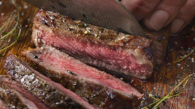 Slicing medium rare thick cut steak