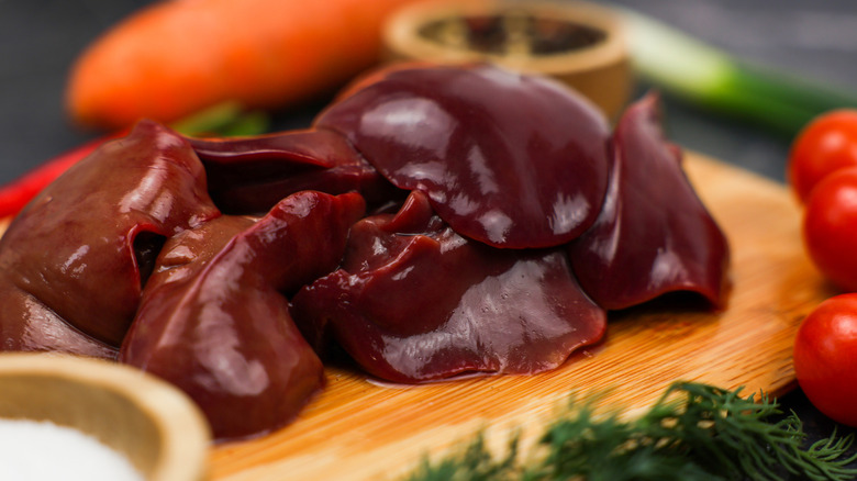 Raw chicken liver is on a cutting board