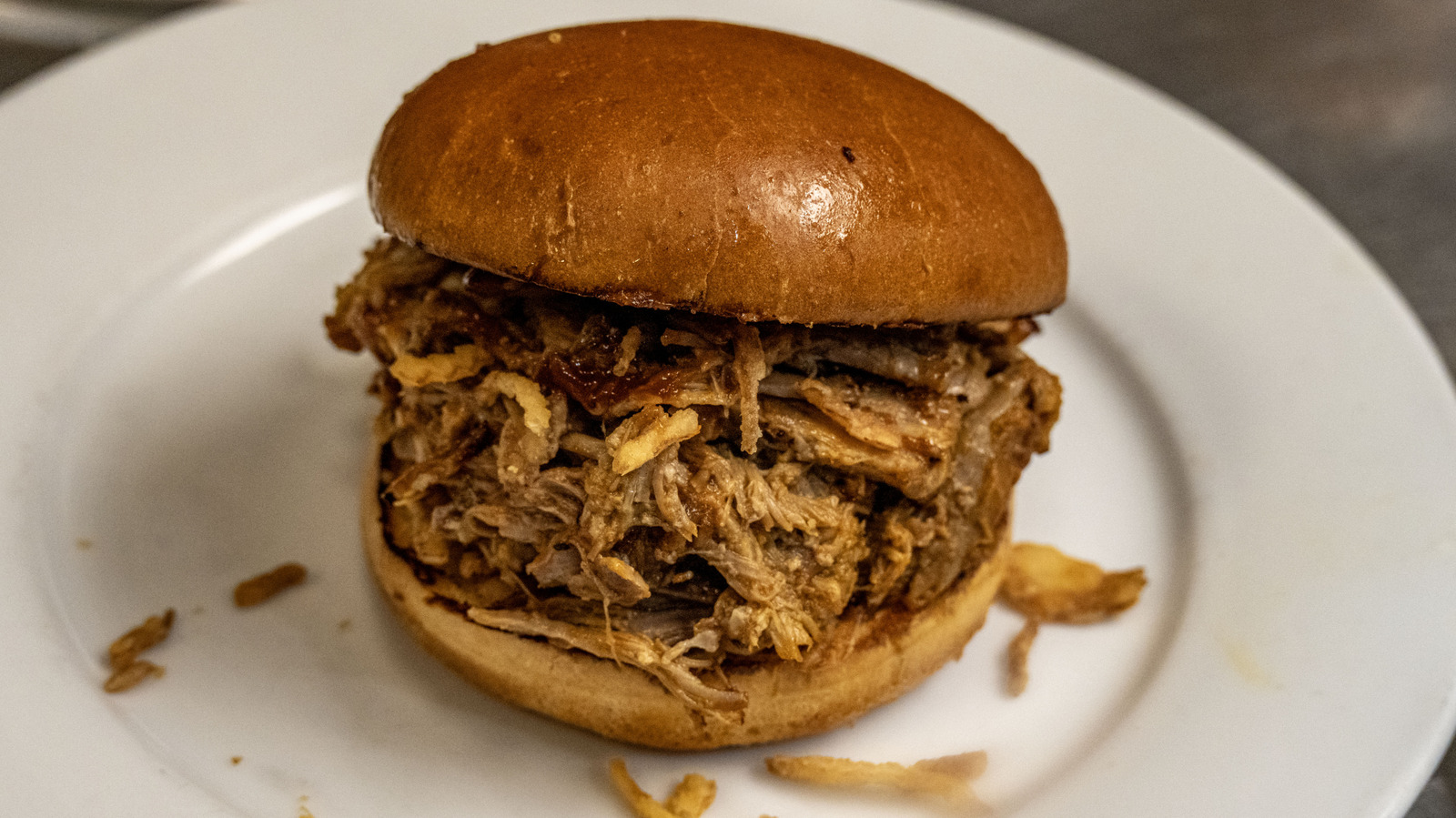 The Classic Cookout Side Dish That Belongs On Your Pulled Pork Sandwich (It's Not Slaw)
