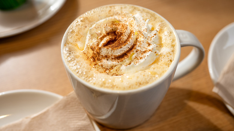 Pumpkin Spice Latte with whipped cream in ceramic mug