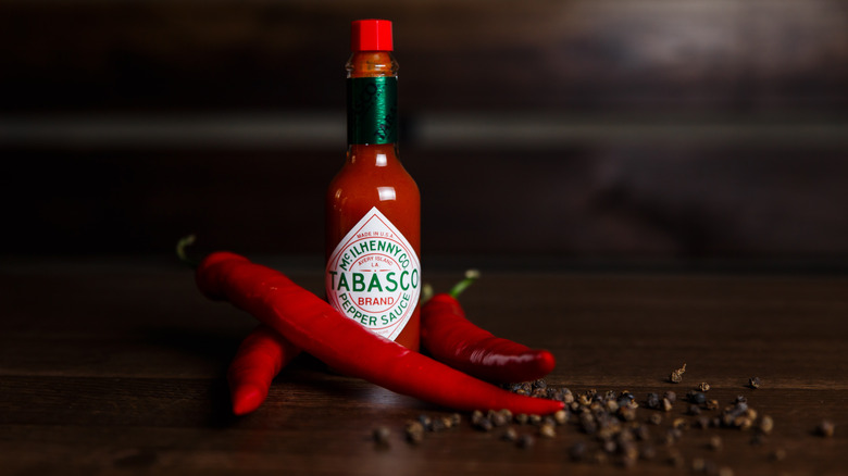 a bottle of hot sauce on a black background