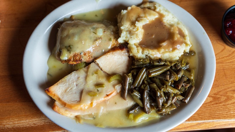 A turkey dinner with mashed potatoes