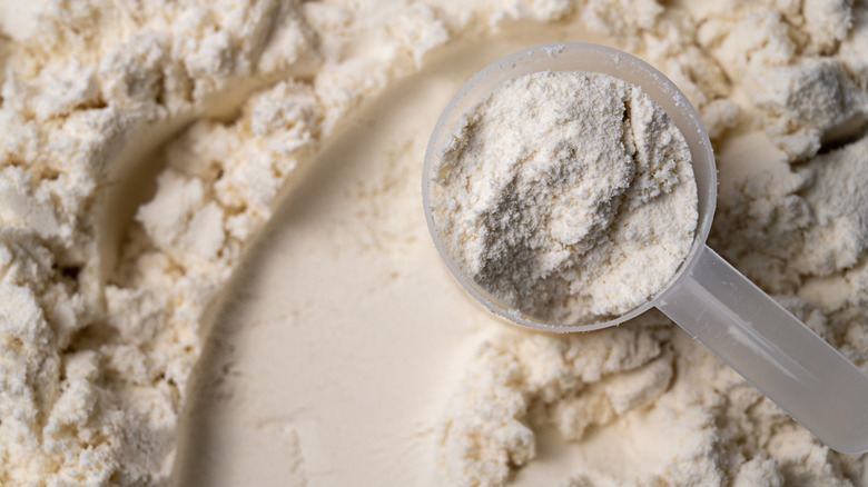 A measuring spoon on a mountain of white flour