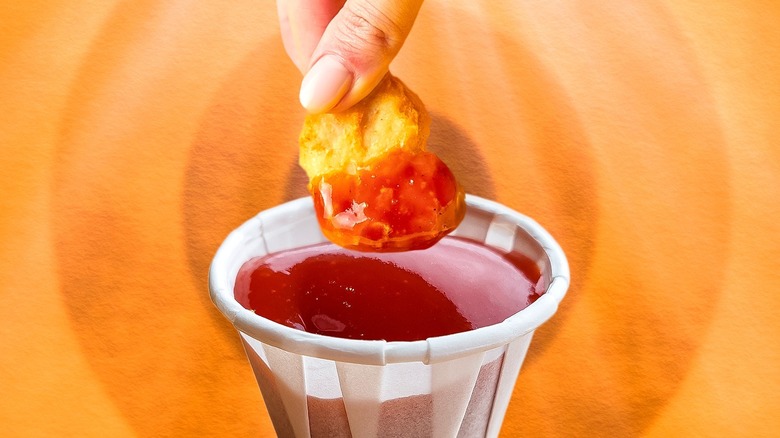 Dipping nugget in ketchup