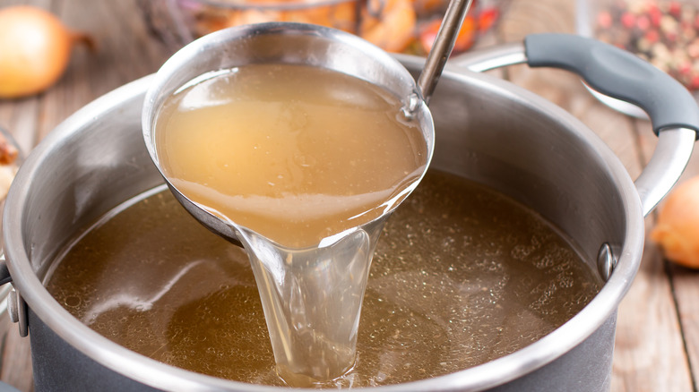 Chicken stock and ladle