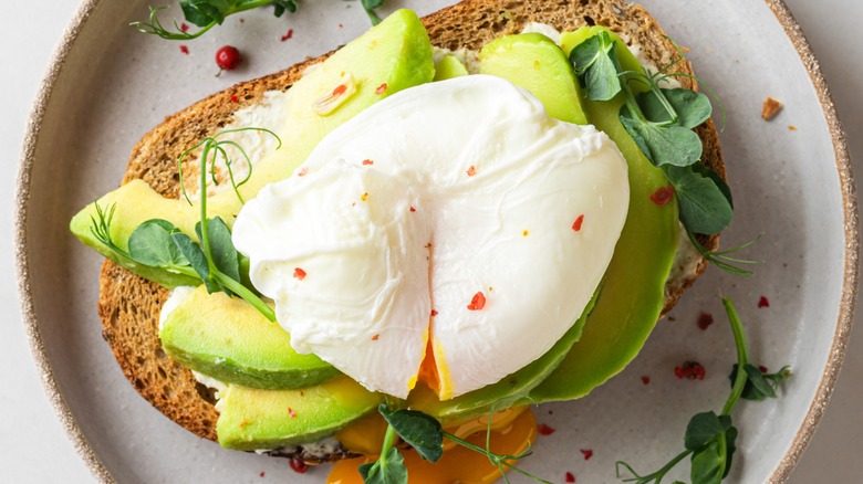 Top-down view of a poached egg on avocado toast