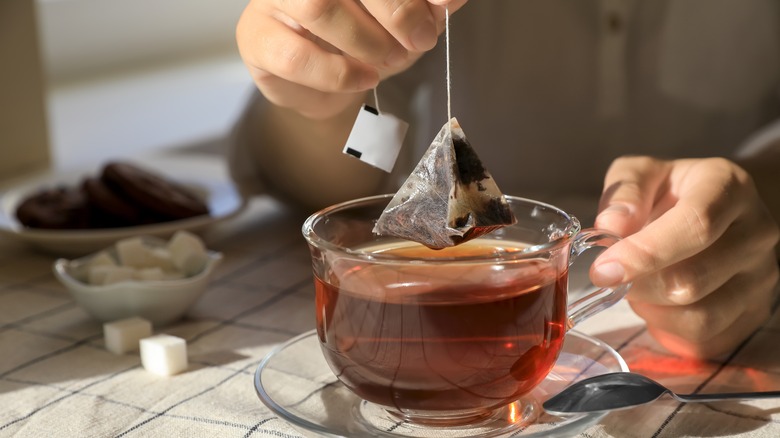 Dunking tea bag in tea cup