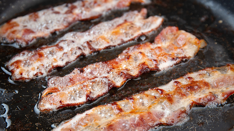 Bacon strips frying