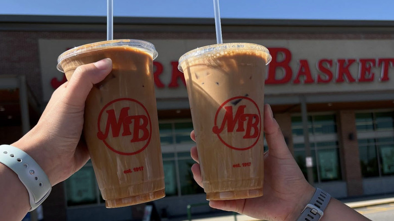shoppers holding Market Basket drinks