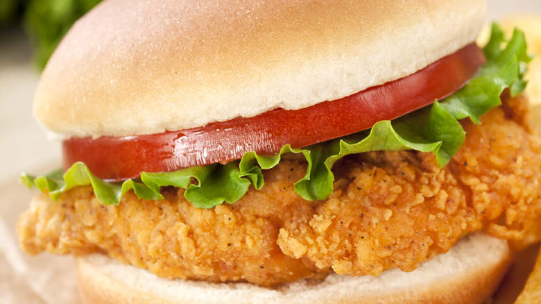 fried chicken sandwich with lettuce and tomatoes