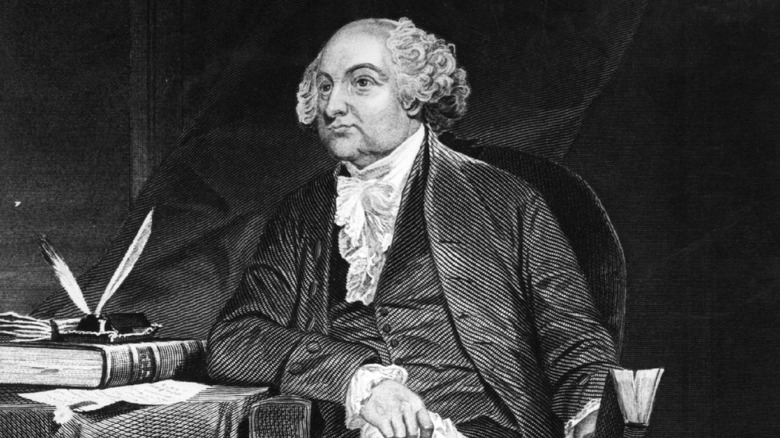 black and white image of John Adams sat in a chair by his desk