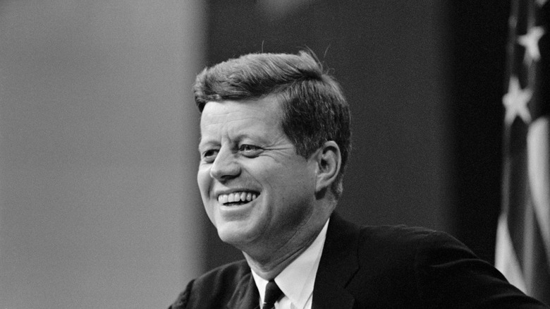black and white image of John F. Kennedy smiling