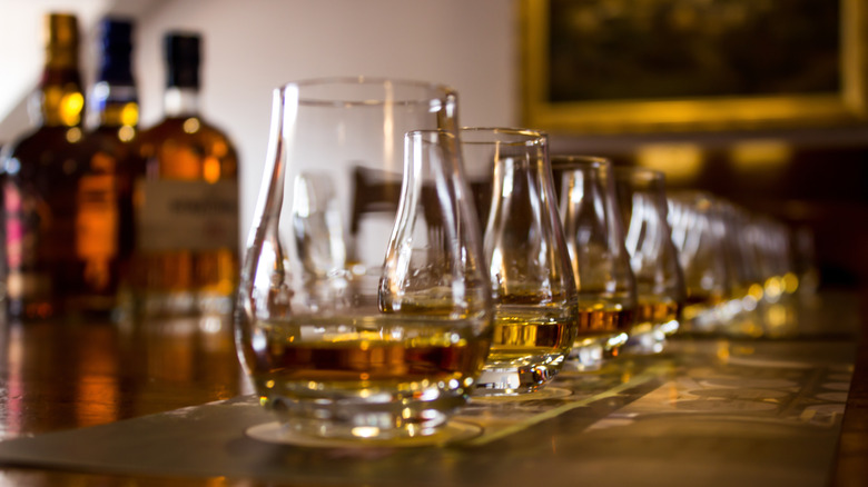 Line of tasting glasses filled with whiskey