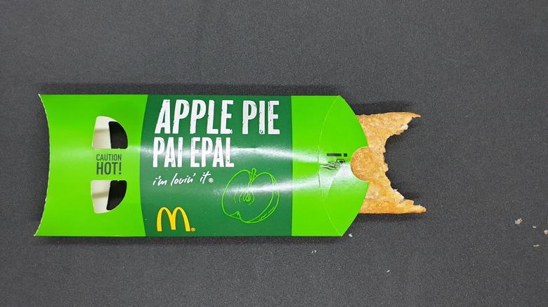 A McDonald's apple pie box, with a bitten pie peeping out