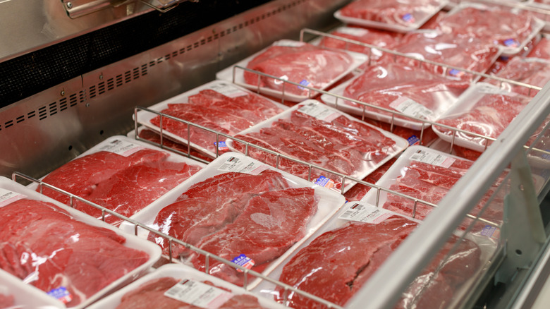 An open cooler stocked with packages of beef at Costco