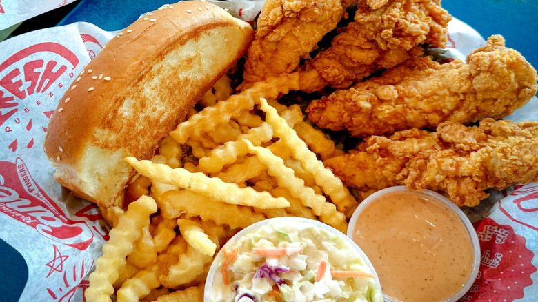 A basket of Raising Cane's food with fries, Texas toast, and chicken fingers