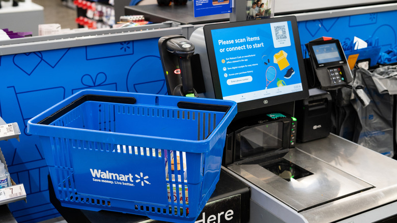 A blue shopping basket placed on the counter at the self-checkout at Walmart