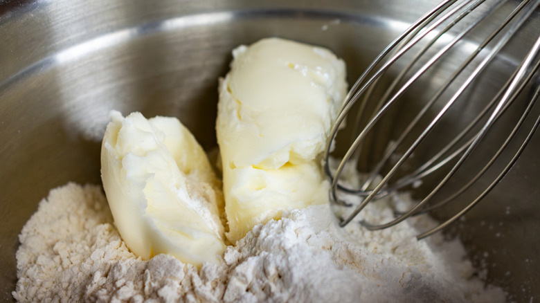 Vegetable shortening and flour in metal mixing bowl with whisk