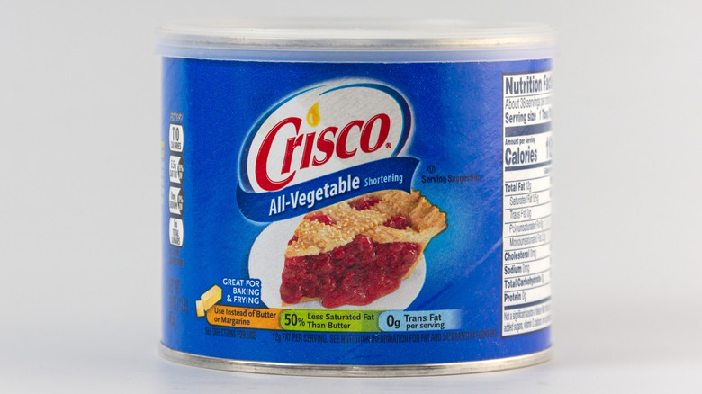 Can of Crisco vegetable shortening on gray background