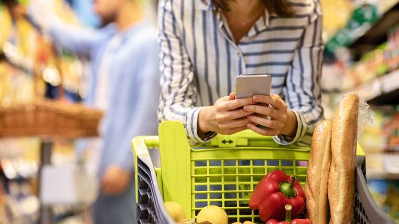 shopper at grocery store on phone