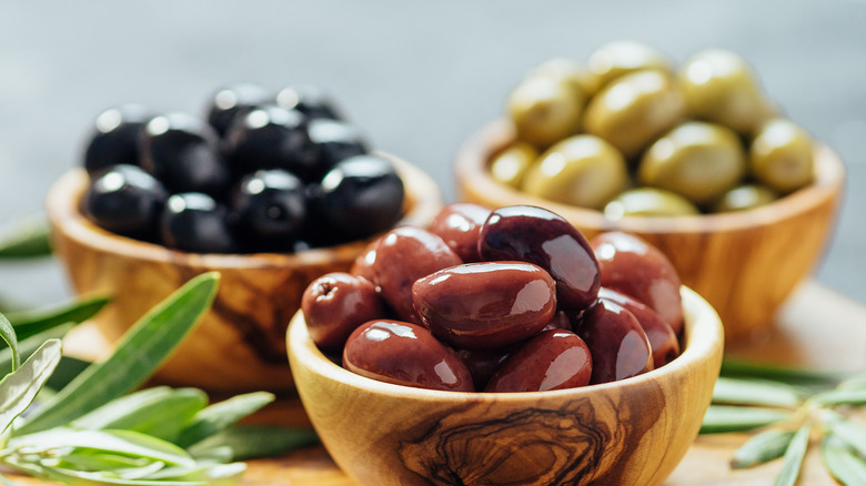 three bowls of different olives