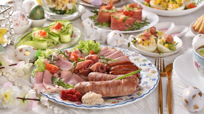 A spread of Polish food, with a plate of sausage in the foreground