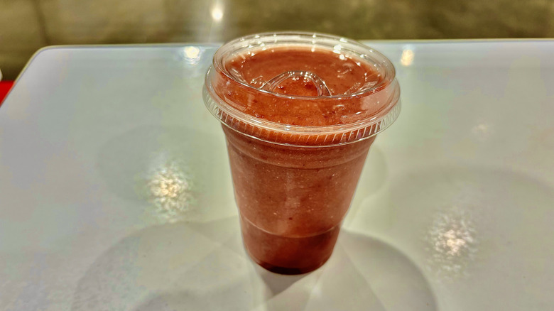 Costco's fruit smoothie in a plastic cup on a table