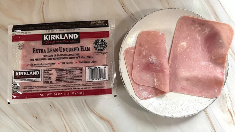 a package of the ham with two slices beside it on a plate