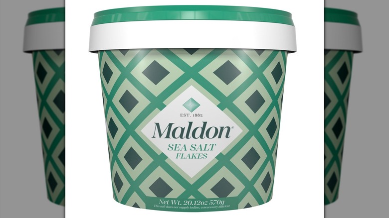 Packaging of Maldon Kosher Sea Salt Flakes Resealable Tub on white background