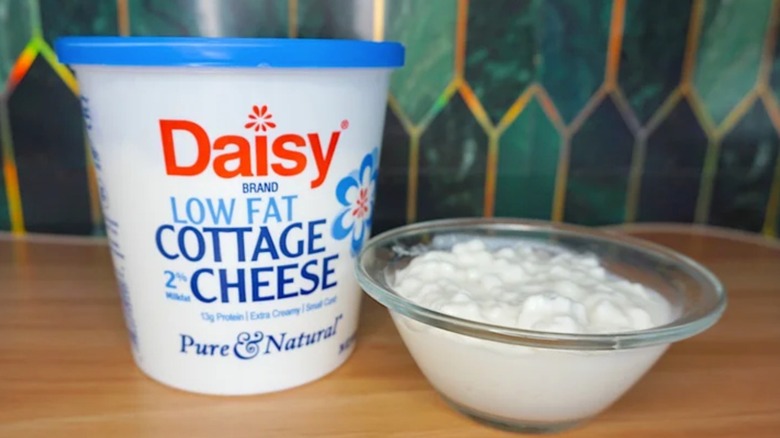 container of Daisy low fat cottage cheese next to a bowl of it